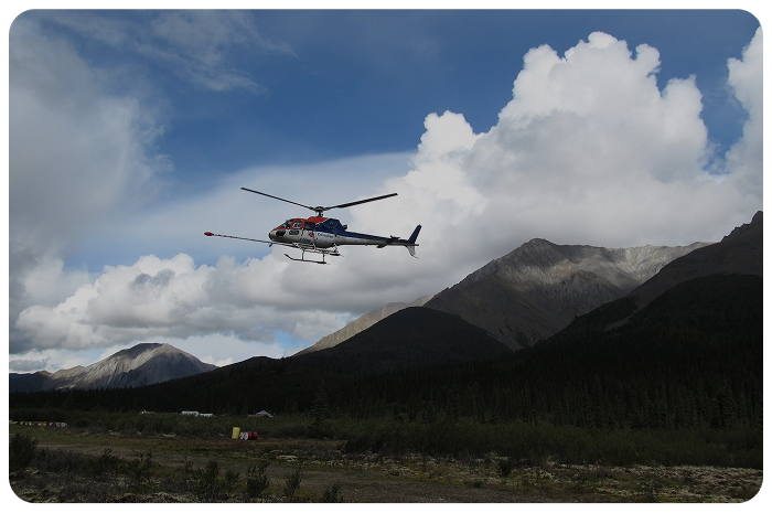 Helicopter flying over mountainous terrain